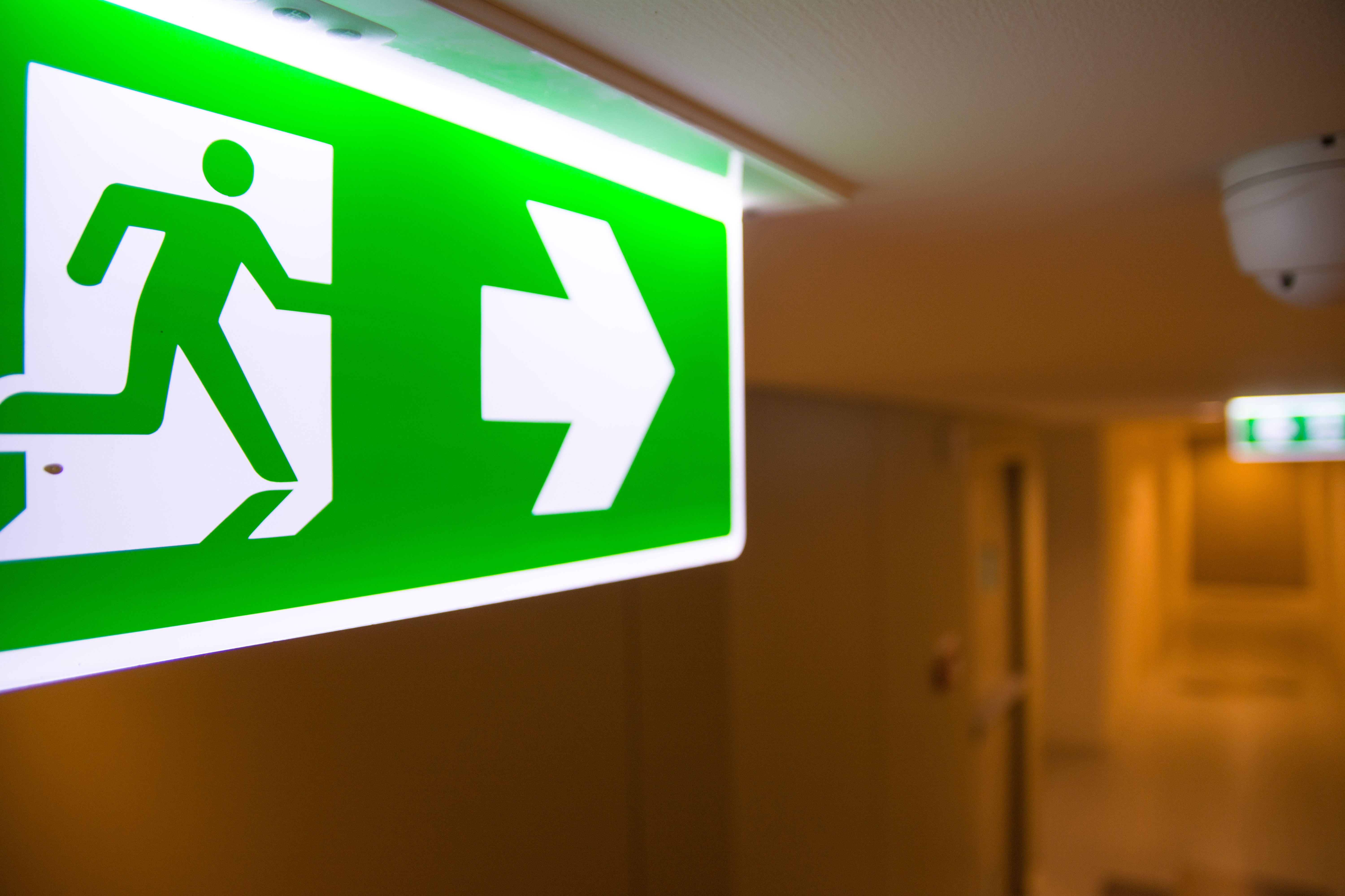 Illuminated wayfinding fire exit sign